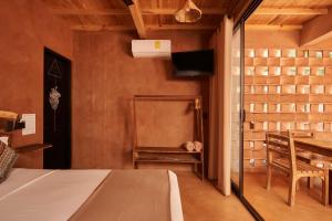 a room with a table and a dining room at Punta Navi - Adults only - Boutique hotel in Puerto Escondido