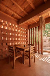 a dining room with a wooden table and chairs at Punta Navi - Adults only - Boutique hotel in Puerto Escondido