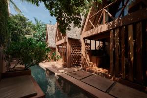 a house with a pool of water next to a building at Punta Navi - Adults only - Boutique hotel in Puerto Escondido