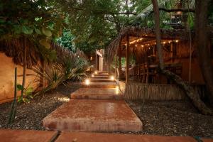 a pathway leading to a house with lights on it at Punta Navi - Adults only - Boutique hotel in Puerto Escondido