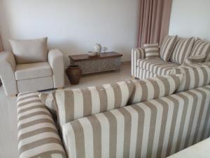 a living room with two couches and a chair at Ananthaya- the infinity in Wadduwa +4 photos