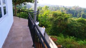 a balcony with a view of a forest at Ananthaya- the infinity in Wadduwa