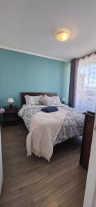 a bedroom with a bed with a blanket on it at Departamento Salar in Calama