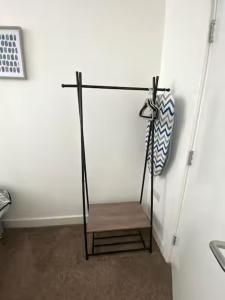 a wooden bench sitting in a room next to a wall at The Failsworth Collection - Stylish Apartments with Free Parking in Manchester