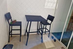 a table and two chairs in a room at 2 Bed Villa Sleeps 4 - Garden Wifi Parking in Temara +4 photos