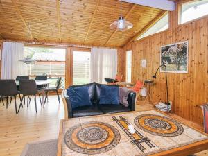a living room with a couch and a table at 4 person holiday home in Store Fuglede in Store Fuglede +65 photos