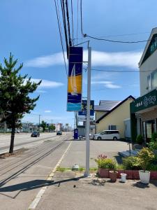 a street sign on a pole on a street at Formosa Hakodate - Vacation STAY 17455 in Hokuto