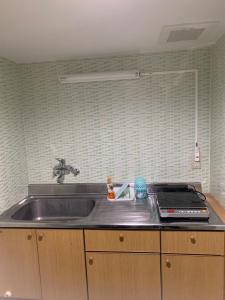 a kitchen with a sink and a stove at Formosa Hakodate - Vacation STAY 17455 in Hokuto +4 photos