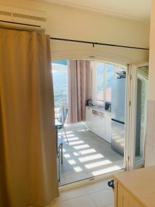 a kitchen with a sliding glass door with a refrigerator at Iris Lucici Aparts in Herceg-Novi +9 photos