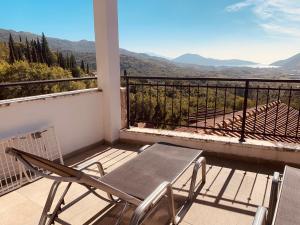 a table and chairs on a balcony with a view at Iris Lucici Aparts in Herceg-Novi