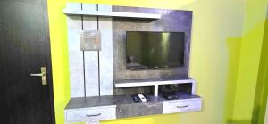 a flat screen tv on a wall in a room at Avante Palace in Rānchī
