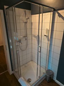 a shower with a glass enclosure in a bathroom at Gasthof Staudham in Wasserburg am Inn