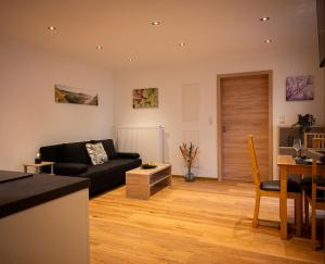 a living room with a couch and a table at Appartements Jupp und Hilde in Ernst