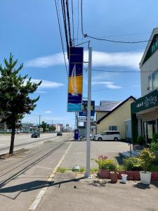 a street sign on a pole on a street at Formosa Hakodate - Vacation STAY 17456 in Hokuto +5 photos