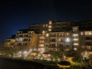 a large apartment building at night with lights at Luxury Aloha Apartments, Rishikesh in Rishīkesh