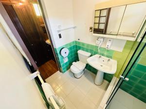 a bathroom with a toilet and a sink at "HOTEL BOUTIQUE LA MAISON DE LA BOLIVIE" Casa de Huéspedes in La Paz +99 photos