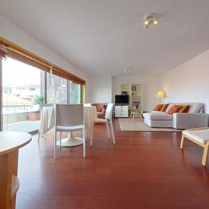 a living room with a couch and a table and chairs at Tasteful Beach Getaway with Private Terrace in Matosinhos