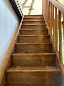 un conjunto de escaleras de madera en una casa en Cosy à la campagne, en Fauverney