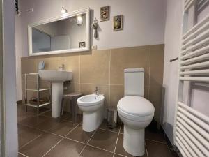 a bathroom with a toilet and a sink at Aurora 88 Apartments in Arezzo +20 photos