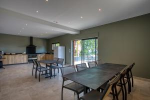 a kitchen and dining room with tables and chairs at Le Pech Eternel - Lodge in Sarlat-la-Canéda