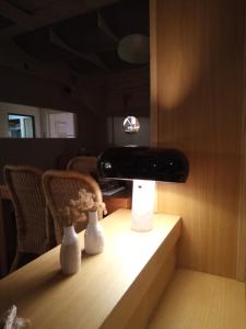 a table with a black suitcase on top of it at Le Relais des Iles in Coudeville