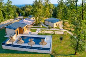 an aerial view of a house with a swimming pool at Le Pech Eternel-Lodge Spa Tilleuls in Sarlat-la-Canéda