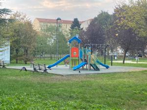 a playground with a slide in a park at I colori della casa di Gio in Grugliasco