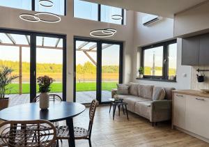 a living room with a couch and a table at Stodoła HowSmart in Grady Szlacheckie