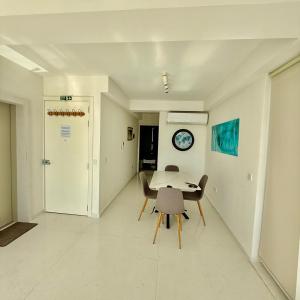 a dining room with a table and chairs at Panoramic & Jacuzzi Seafront, Seaview Sliema Penthouse in Il-Gżira taʼ Forti Manoel