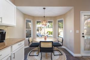 a kitchen and dining room with a table and chairs at Boho 4BR Retreat with Heated Pool, Spa and Tiki Bar in Gilbert