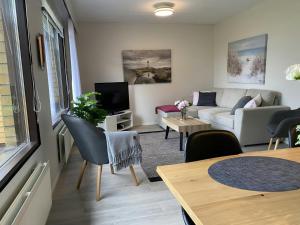 a living room with a couch and a table at Spacious Apartment for 6 with Sauna in Kemi