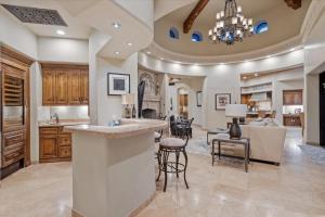 a kitchen with a bar and a living room at Romantic 4BR Hacienda with Pool, Spa and Close to Town in Cave Creek