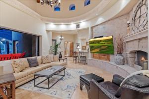 a living room with a couch and a fireplace at Romantic 4BR Hacienda with Pool, Spa and Close to Town in Cave Creek