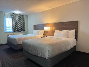 a hotel room with two beds and a window at Quality Inn By Choice Hotels - West Des Moines - I 235 & I 80 in West Des Moines