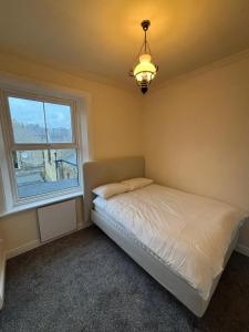 a bedroom with a bed and a window at Central Gravesend 1 Bed Flat in Gravesend