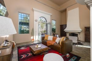 a living room with a couch and a table at Chic 3BR Estate with Stables, Pool and Pickleball in Carefree