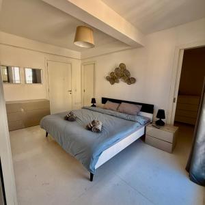 a bedroom with two cats laying on a bed at Panoramic & Jacuzzi Seafront, Seaview Sliema Penthouse in Il-Gżira taʼ Forti Manoel