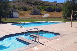 a large swimming pool with stairs in a yard at Boardwalk in Garden City