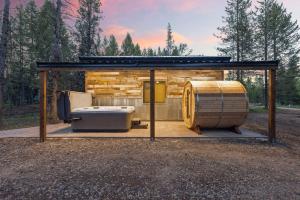 a shed with a hot tub and a barrel at Timber and Tin in Island Park