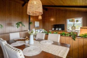 a dining room with a wooden table and chairs at Morden Rustic 6B3B Ocean Mountain View BBQ EV Charging in Oak Harbor
