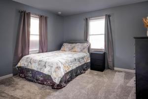a bedroom with a bed and two windows at Mineola Bay Lakeview and Access Fully Furnished Monthly and Seasonal Rental in Fox Lake in Fox Lake