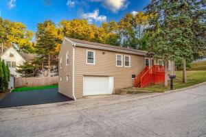 a house with a garage on a street at Mineola Bay Lakeview and Access Fully Furnished Monthly and Seasonal Rental in Fox Lake in Fox Lake