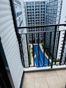 an apartment balcony with a view of a building at MOA GRAND STAY Suite 03 Spacious Unit ! in Manila