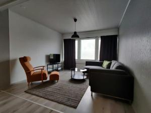 a living room with a couch and a table at Central and Spacious Apartment for 11 in Kemi