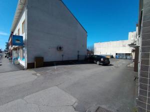 a car parked in a parking lot next to a building at Central and Spacious Apartment for 11 in Kemi