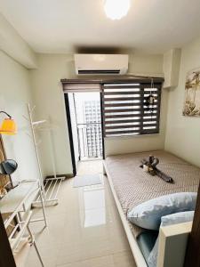 a small room with a bed and a window at MOA GRAND STAY Suite 03 Spacious Unit ! in Manila