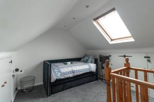a bedroom with a bed and a skylight at Stylish 3 BD | Prime Location | Fast train to London in Bickley +48 photos