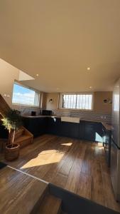 a large room with wooden floors and a large window at L'atelier de la Tour - Gite indépendant entièrement équipé in Le Plessis-la-Tour +7 photos