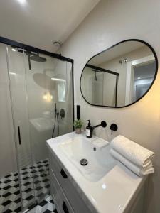 a bathroom with a white sink and a mirror at Apartamentos Casa Miguel in Andújar +21 photos
