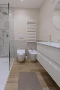 a bathroom with a toilet and a sink and a shower at Homarè in Cerisola +14 photos